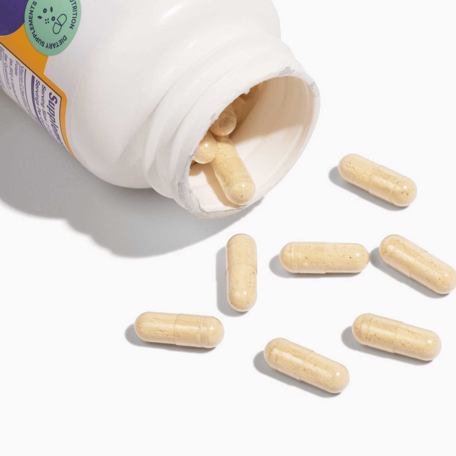 Bariatric Glow supplement capsules spilled from bottle, promoting healthy hair, skin, and nails for bariatric patients.